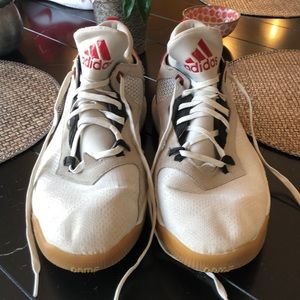 Red, white, and black Adidas basketball shoes.